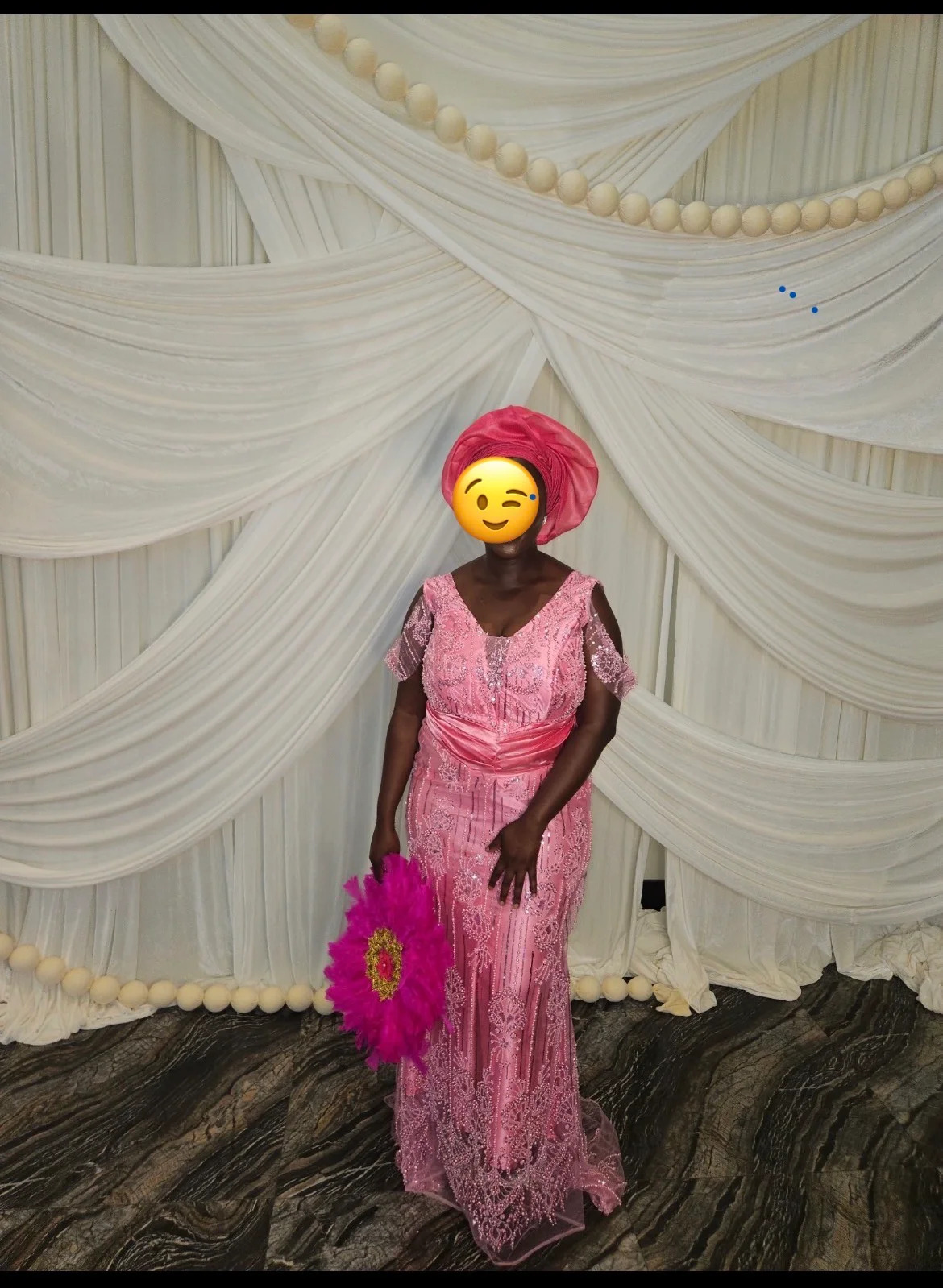Client in a beaded pink lace formal gown at an event