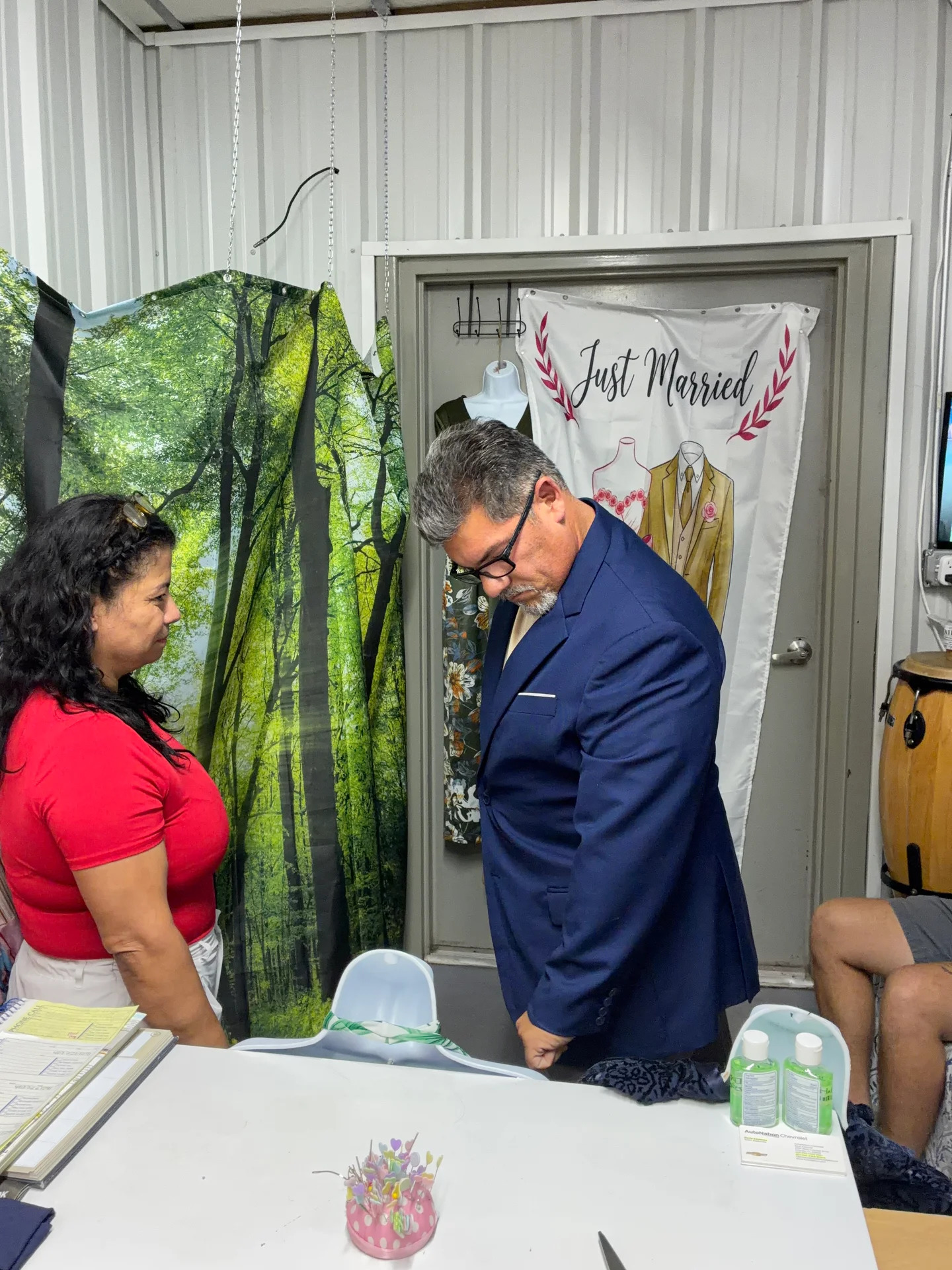 Esperanza fitting a client's navy suit jacket