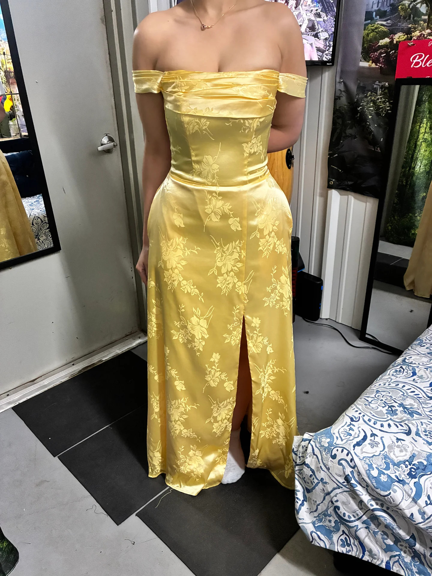 Yellow floral satin off-shoulder gown after fitting